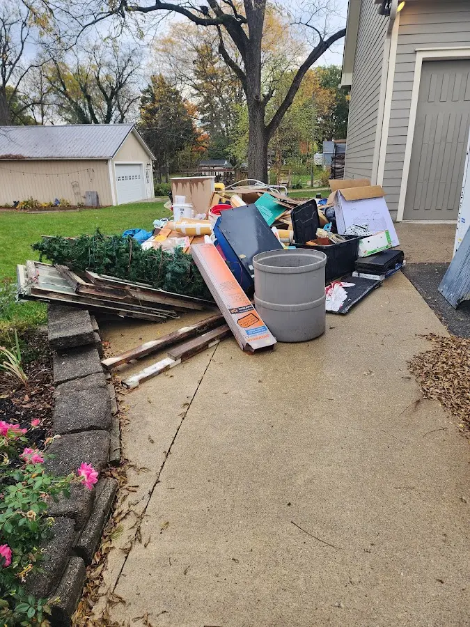 Dumpster being loaded with debris for 10 Yard Dumpster Rental in Beverly